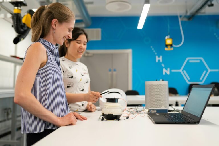 Two female engineers working on research and development in a modern laboratory setting.