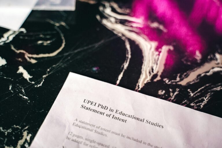 Close-up of a statement of intent document on a marbled surface with bright pink reflections.